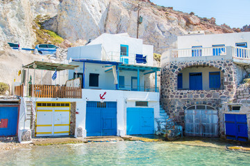Fototapeta na wymiar Traditional colorful fishing houses near the beach in Firopotamos village in Milos island, Cyclades, Greece