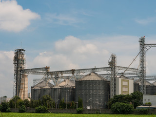 Industrial factory of animal feed storage and Blue sky with clouds.