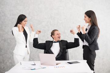 Celebrating success Cheerful young people looking excited. Successful entrepreneurs and business people achieving goals