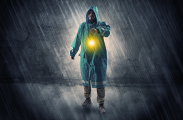 Fototapeta premium Ugly wayfarer with lantern in his hand in front of a crumbly wall concept 