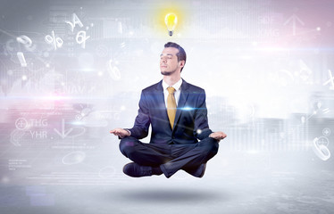 Businessman meditates with enlightenment data reports and financial concept

