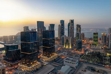 Deurstickers Midden-Oosten Zonsopgang boven de skyline van Doha, Qatar, met de talrijke, moderne wolkenkrabbers