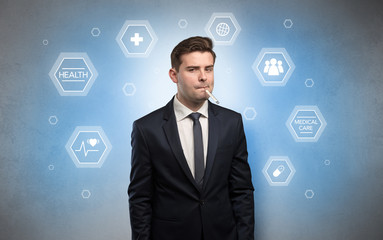 Young businessman with medical care, pills concept
