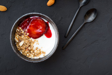 Home made granola with yogurt and caramelized plums