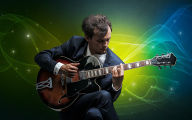 Obraz premium Serious classical guitarist with fabled sparkling wallpaper