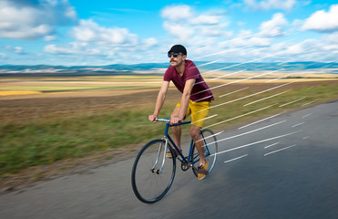 Fototapeta premium Casual hipster cyclist riding bicycle with high speed concept