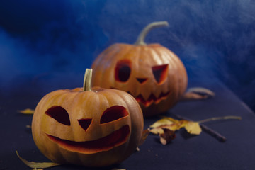 Halloween pumpkin lantern with dry leaves