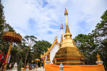 Naklejka premium Wat Phra That Doi Tung temple with public domain has two golden pagodas or stupas containing Buddha's relic, considered as a treasure of Buddhism, Mae Sai, Chiang Rai, Thailand. Thai Travel Tourism.
