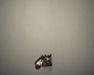 Young businessman contemplating a decision standing on a grey surface