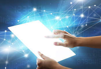 Young female hand holding a tablet with numbers in the background