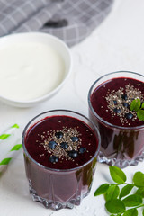 Delicious wild blueberry smoothie milk yogurt ice cream gray background summer drink concept