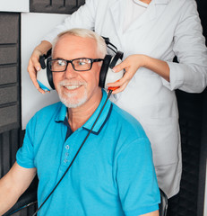 Senior man getting a hearing test at a doctors office, audiometer hearing test