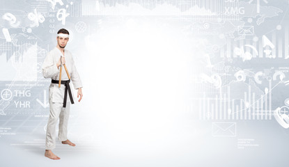 Young karate trainer doing karate tricks on the top of a metropolitan city
