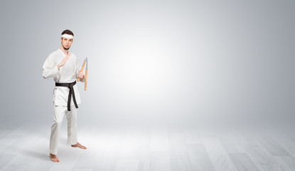 Young kung-fu trainer fighting in an empty space
