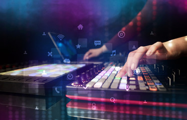 Fototapeta na wymiar Hand mixing music on dj controller with social media concept icons 