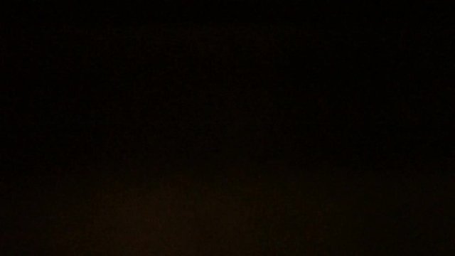 A subway train passes a station underground