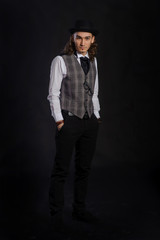 Fototapeta premium The handsome caucasian young man in a white shirt, suit and hat