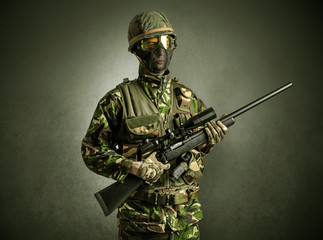 Soldier agent in a dark room with arms on his hand and gas mask
