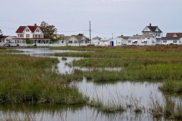 Houses on the marshes of Tangier Island, Virginia, in the Chesapeake Bay. Since 1850 the island’s...