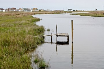 An old wooden dock in a marsh on Tangier Island, Virginia, in the Chesapeake Bay. Since 1850 the island’s landmass has been reduced by 67%; the remaining landmass is expected to be lost by 2068.
