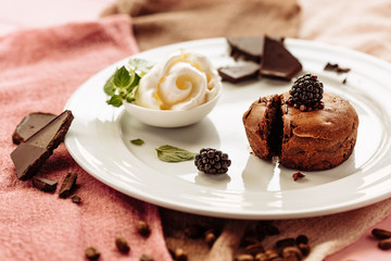 chocolate Fondan with syrup and ice-cream on a plate decorated with mint leaves