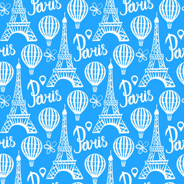 Winter seamless pattern. Paris Eiffel Tower. Vector white illustration isolated on blue background.