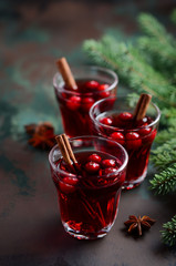 Mulled red wine with cranberries. Holiday Concept Decorated with Fir Branches and Spices.
