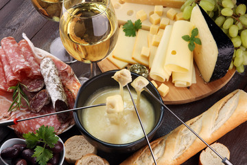 Gourmet Swiss fondue dinner on a winter evening with assorted cheese
