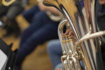 A person playing a silver plated tuba in rehearsal - obrazy, fototapety, plakaty