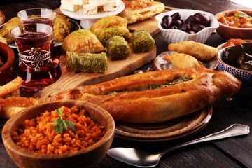 Middle eastern or arabic dishes and assorted meze, concrete rustic background. sambusak. Turkish Dessert Baklava with pistachio. Sarma. Halal food. Lebanese