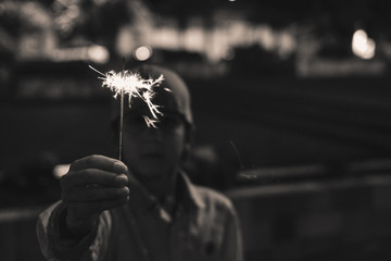boy playing with sparklers