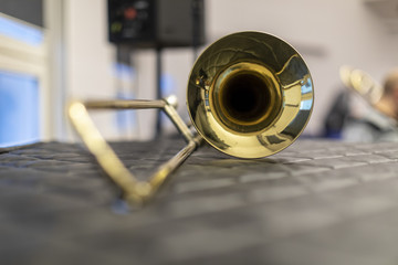 A trombone resting on a soft surface