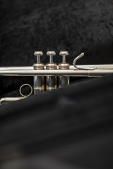 A silver plated trumpet in a black soft case