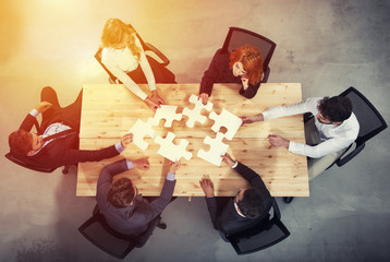 Teamwork of partners. Concept of integration and startup with puzzle pieces