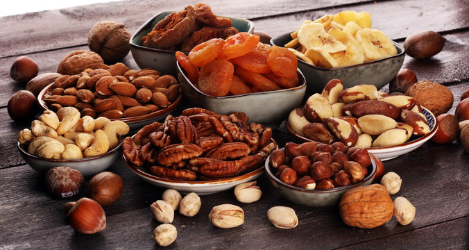 dried fruits and assorted nuts composition on rustic table