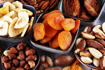 dried fruits and assorted nuts composition on rustic table