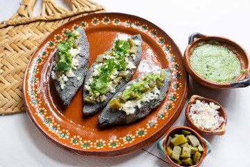 Mexican tlacoyos with green sauce