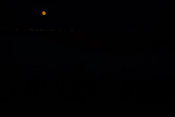 full moon and light lanterns in black sky