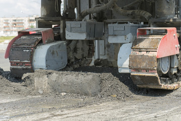 Fototapeta na wymiar Machinery for asphalting roads. Road Roller works to cut a path