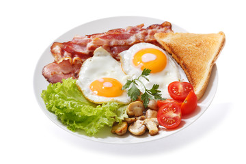 plate of fried eggs, bacon, mushrooms and toast on white background