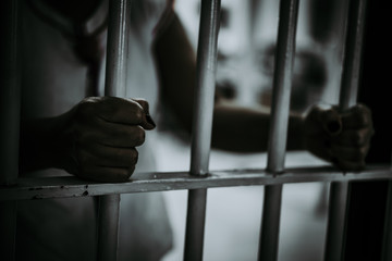 Portrait of woman desperate to catch the iron prison,prisoner concept,thailand people,Hope to be free.