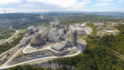 Verkhnebakansky cement plant, top view. Factory for the production and preparation of building cement. Cement industry. - obrazy, fototapety, plakaty