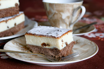 Piece of chocolate cake with chesse and cup of tea
