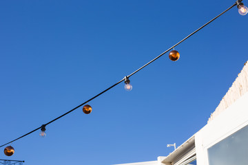 Christmas balls hanging against the blue sky