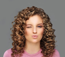 Teenage girl grimacing.Portrait of winking girl.