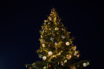 Christmas tree with garland and balls at Night