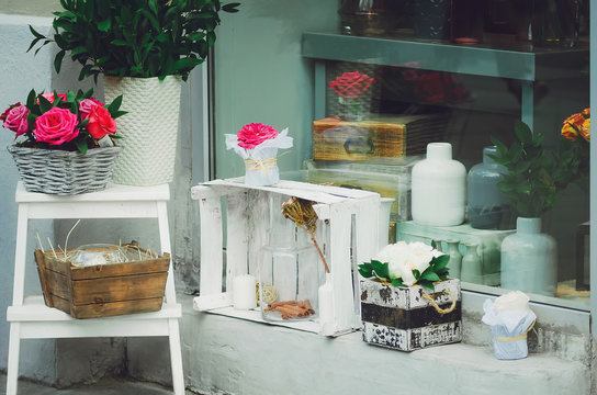 Beautifully designed storefront, flowers and glass vessels. Vintage style.