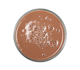Chocolate milk puddle in glass isolated on white background, top view