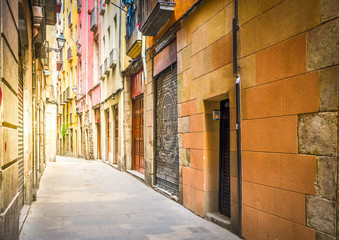 narrow street in Barrio Gotic quarter of Barcelona, Spain, toned
