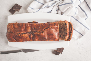 Homemade chocolate bread (cake) on a white background.